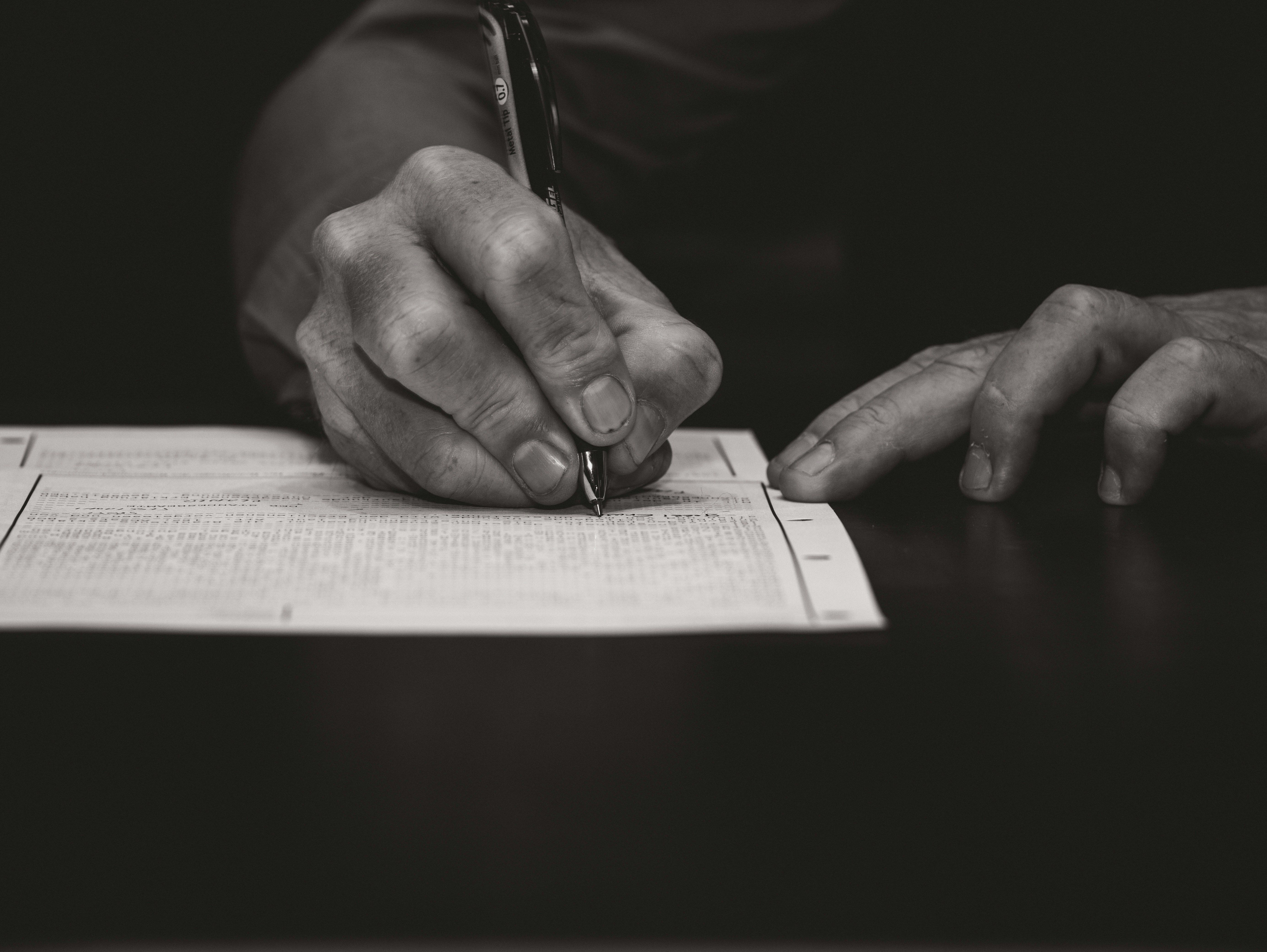 Pen signing a withdrawal document