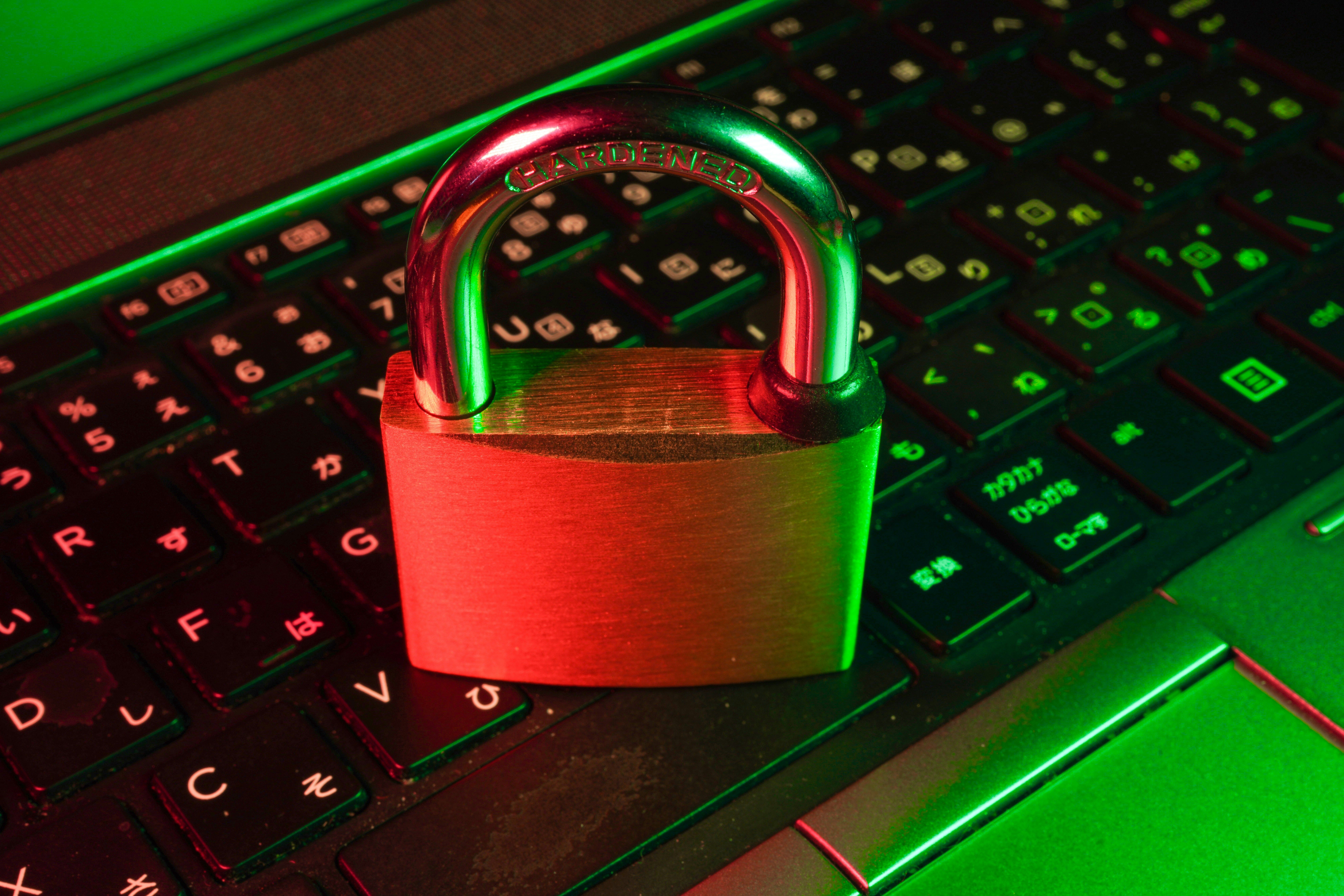 Laptop with cybersecurity warning representing IEEPA refund scam prevention