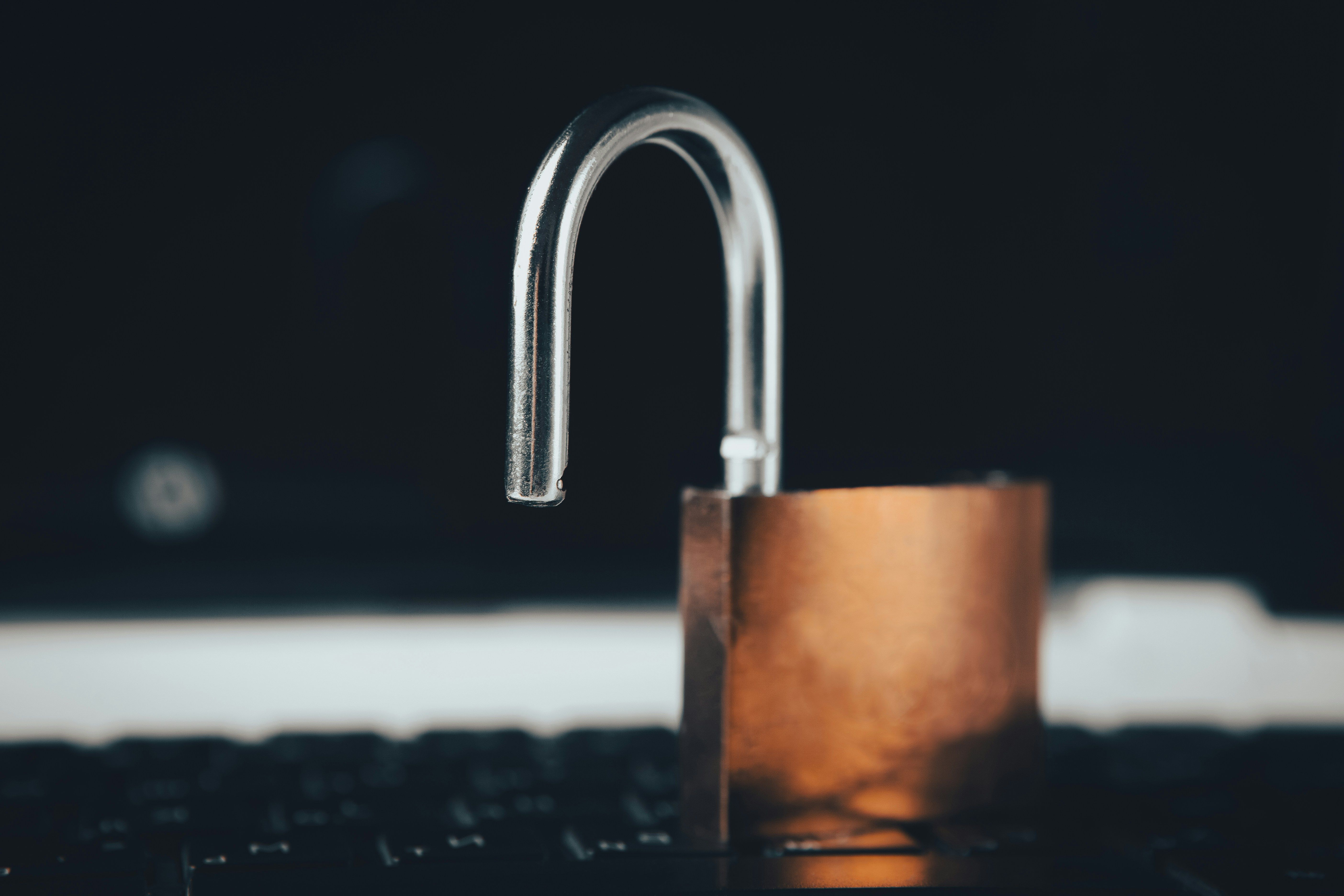 A padlock resting on top of a laptop computer, illustrating a locked ACE Portal account
